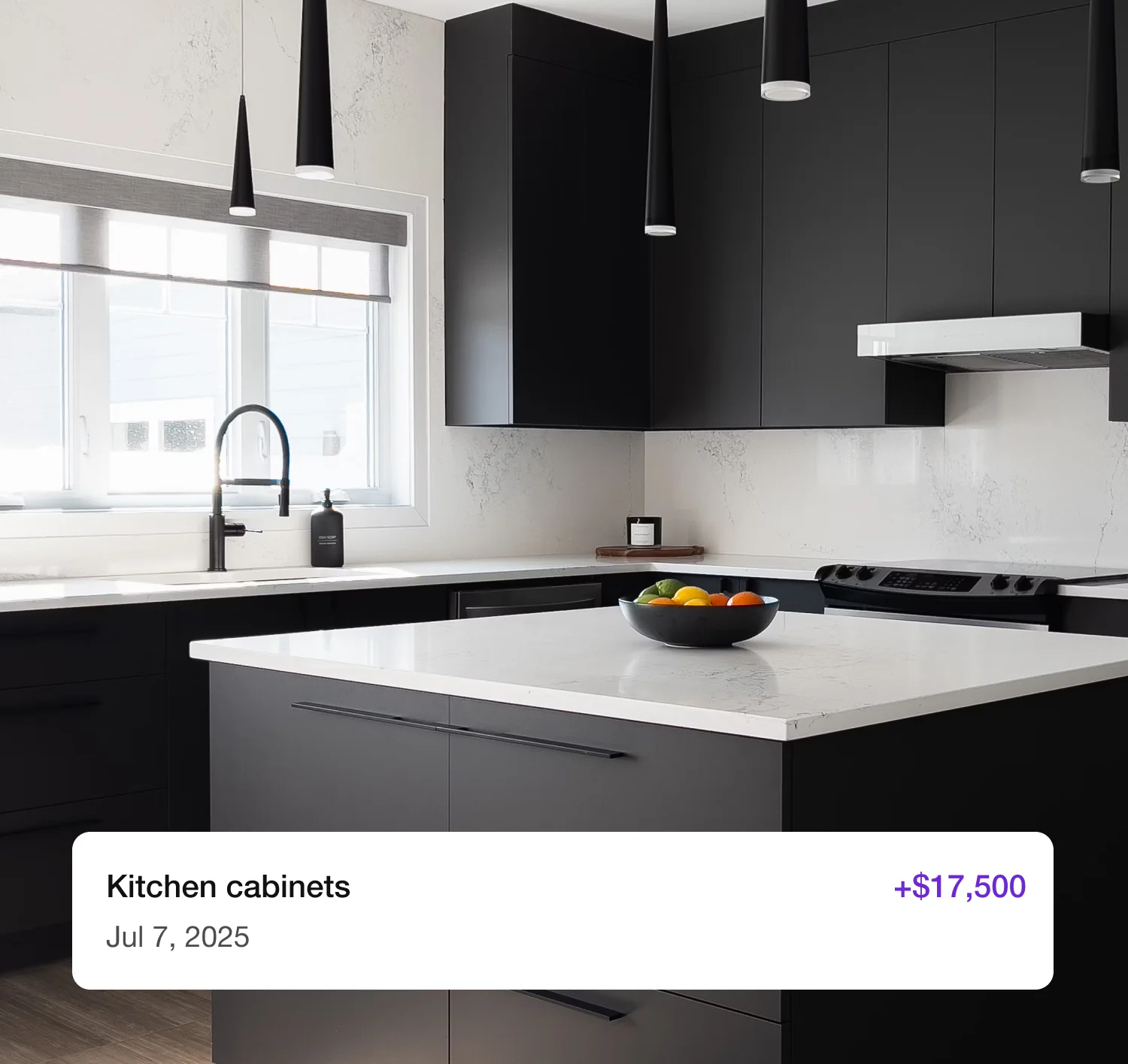 A modern kitchen with black cabinets and a marble island